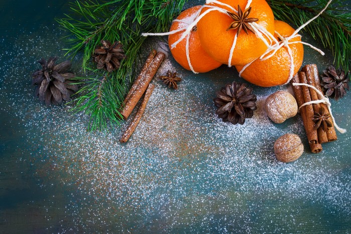Christmas still life with mandarins, cinnamon, pine cones, and nuts