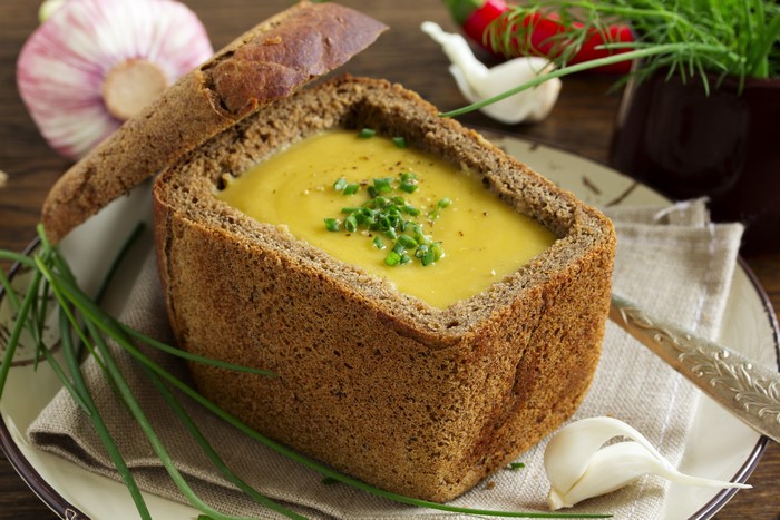Lentil soup in a bread bowl with chives