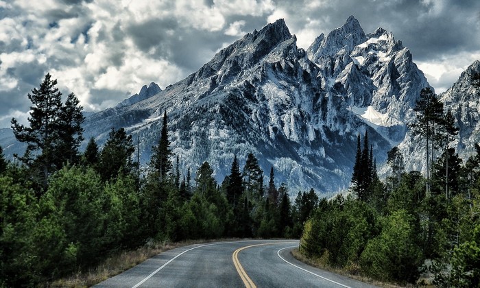 Winding Road Leading to Majestic Mountains