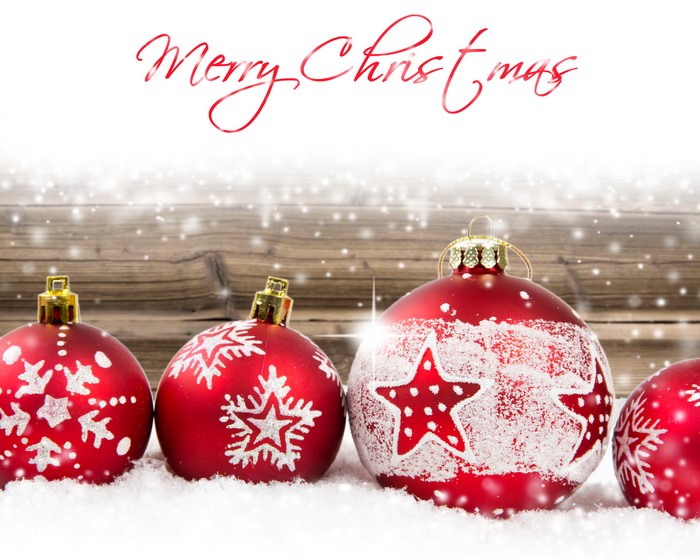 Christmas balls with snow and wooden background