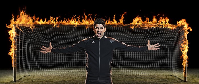 Diego Costa in front of a burning soccer goal
