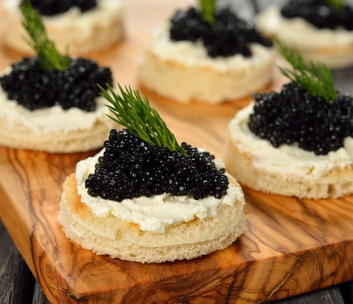 Caviar on toast with cream cheese and dill
