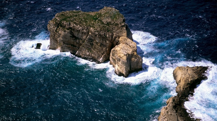 Rocky islands in the ocean with waves crashing