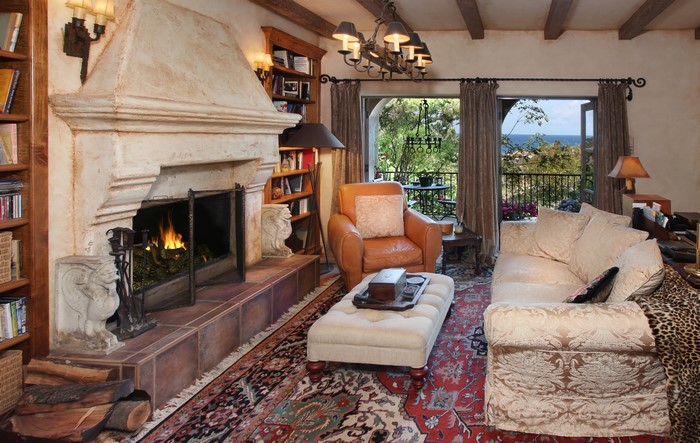 Living room with fireplace, sofa, and armchair