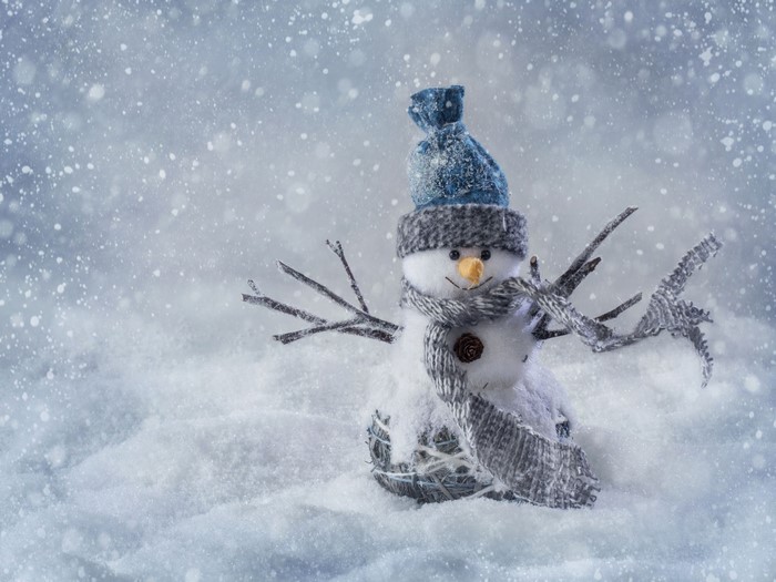 Snowman with hat and scarf in snow