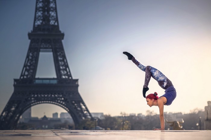 Quincy Azzario performing gymnastics in front of the Eiffel Tower in Paris