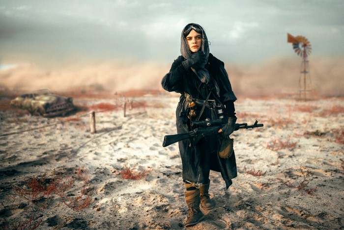 Woman with sniper rifle in a desert wasteland