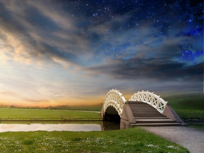 White bridge over a river with a starry sky