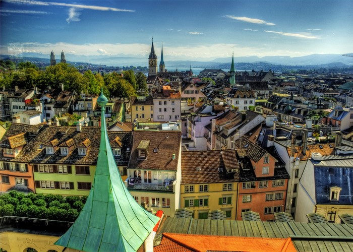 Zurich cityscape with churches and mountains