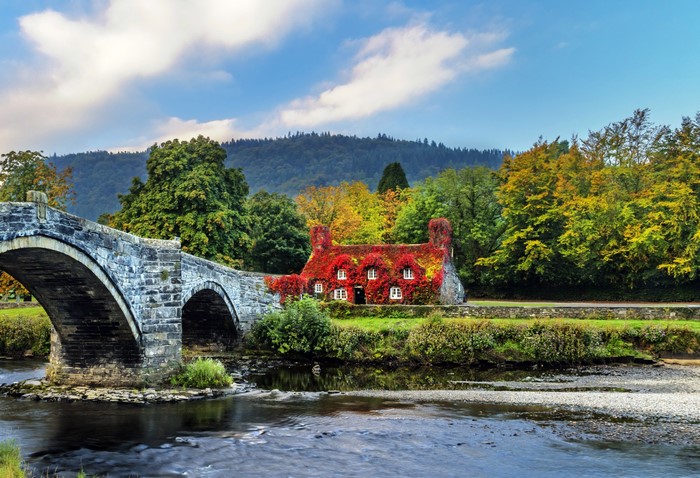 Stone bridge and ivy-covered house in Llanrwst, Wales