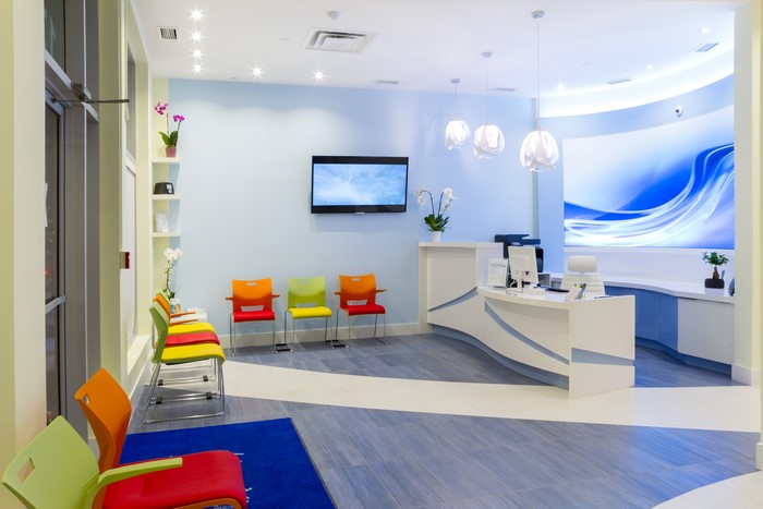 Modern waiting room with colorful chairs and reception desk