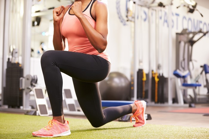 Woman performing lunges in a gym