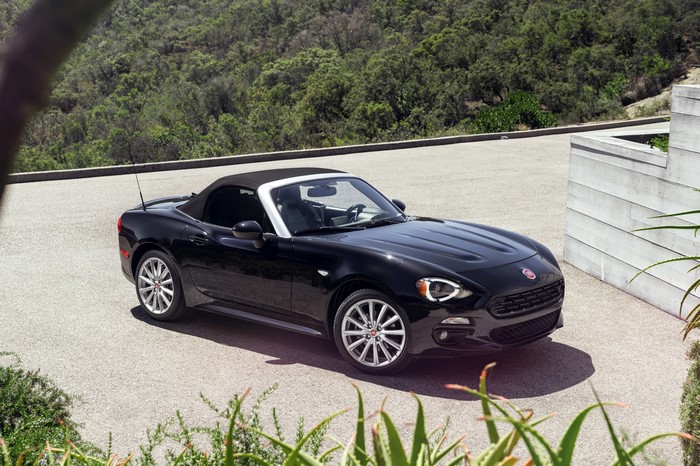Black Fiat 124 Spider convertible parked outdoors