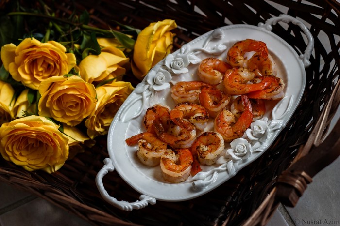 Cooked Shrimp on a Decorative Plate with Yellow Roses