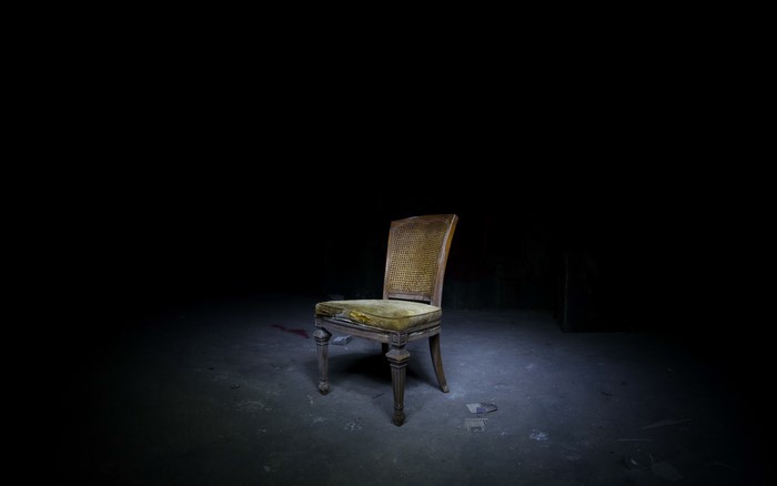 An old chair in a dark room