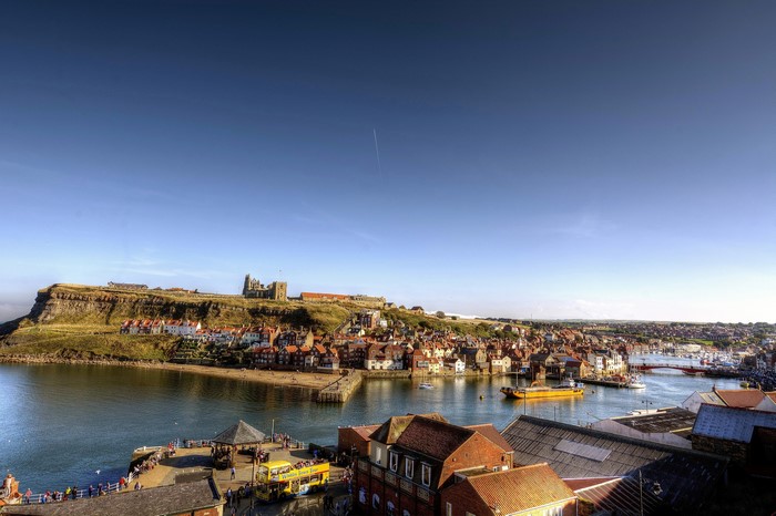 Whitby, North Yorkshire, United Kingdom harbor with Abbey ruins