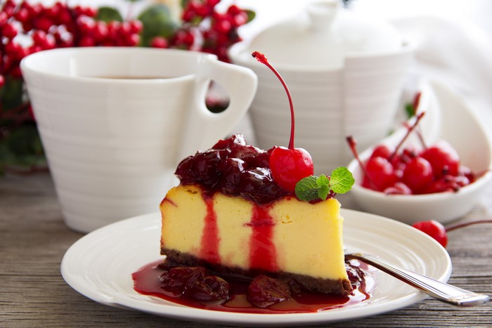 Cheesecake with cherry topping and tea