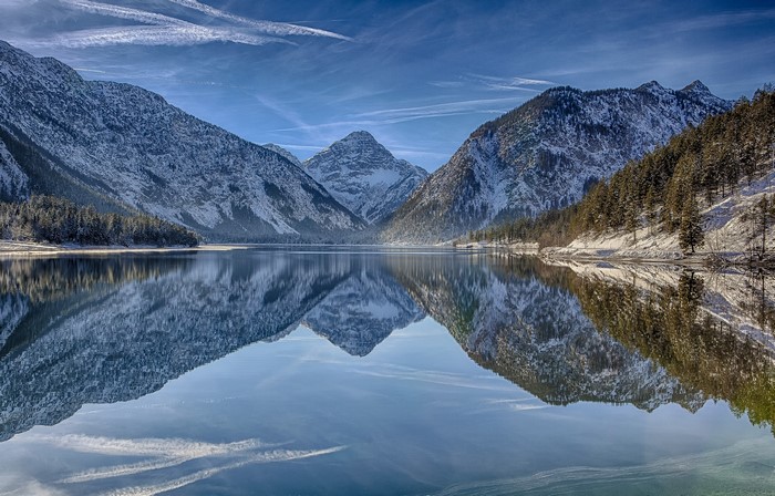 Snow-capped mountains reflected in a calm lake