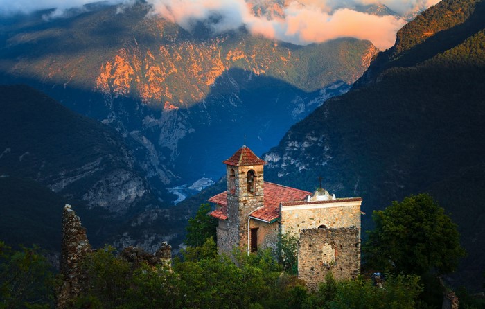 Stone church on a mountain ridge overlooking a valley in France