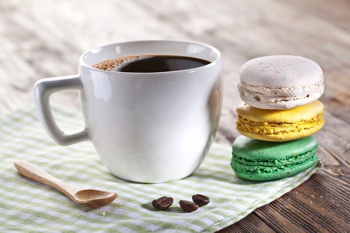 Coffee Cup with Colorful Macarons Closeup 4K