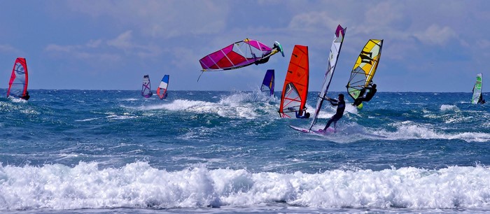Windsurfers riding waves on a sunny day