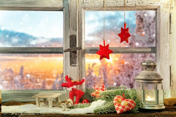 Christmas window with snowy landscape and decorations
