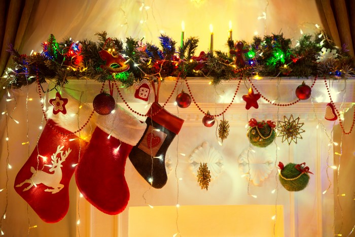 Christmas fireplace mantel with stockings and lights