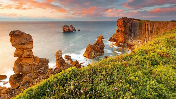 Coastal cliffs and rock formations at sunset