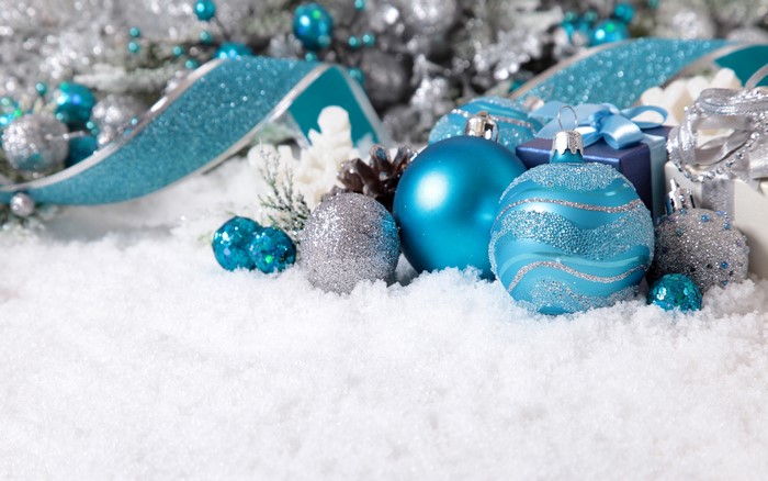 Christmas ornaments and ribbon on snow