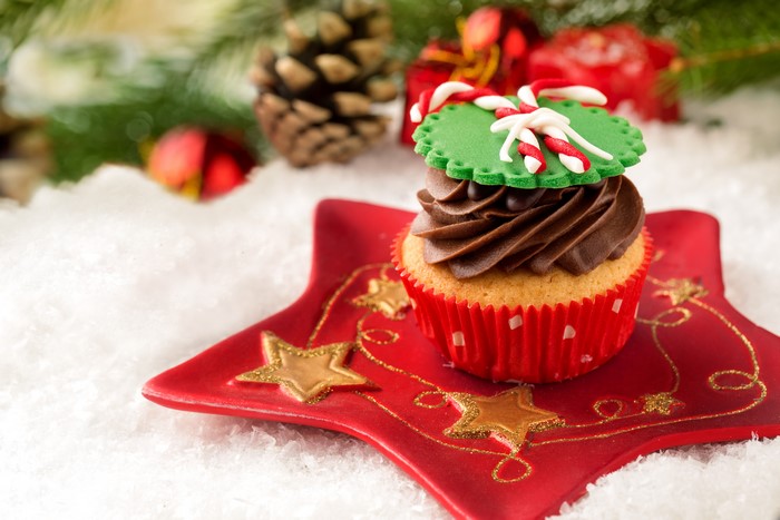Christmas cupcake with chocolate frosting and candy cane decoration