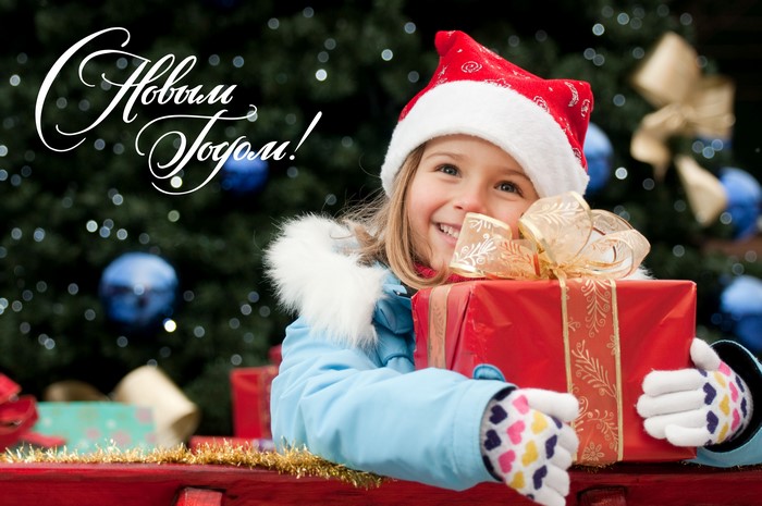 Little girl in Santa hat with Christmas gift