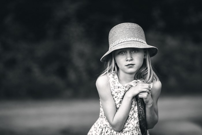 Young girl in a straw hat and floral dress
