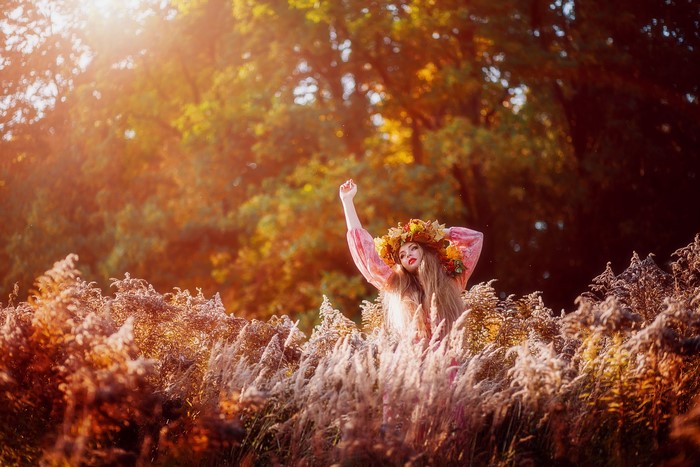 Woman with leaf crown in a field