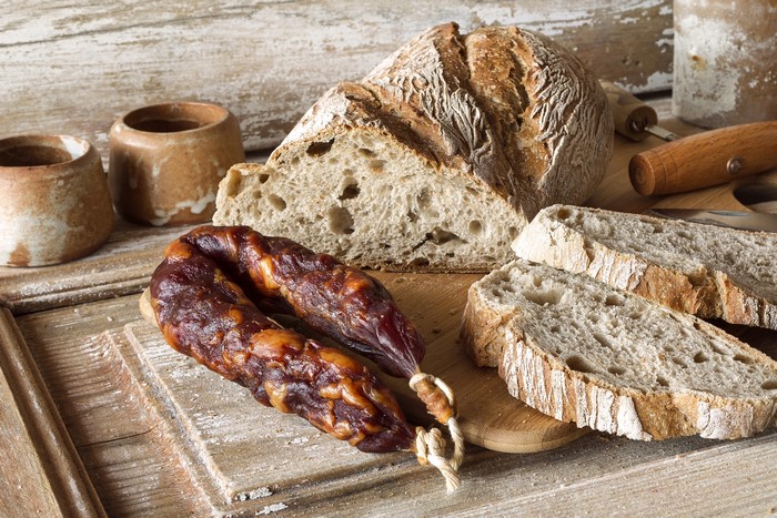 Sausage and Bread on a Wooden Table