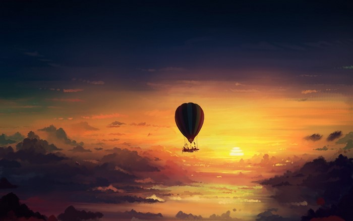 Hot air balloon flying over clouds at sunset