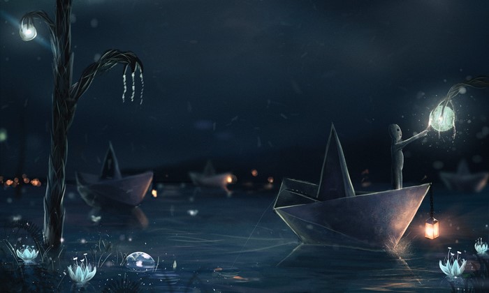 Paper boats with glowing lanterns on water at night