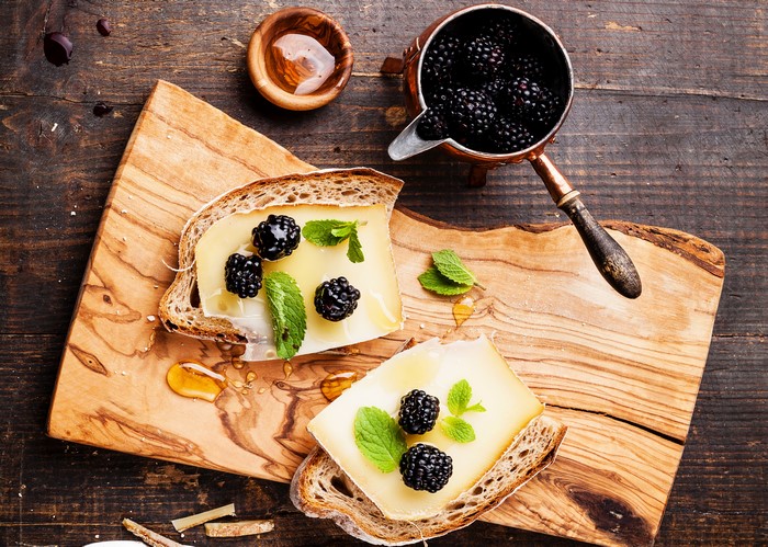 Cheese and Blackberry Butterbrot on a Wooden Board
