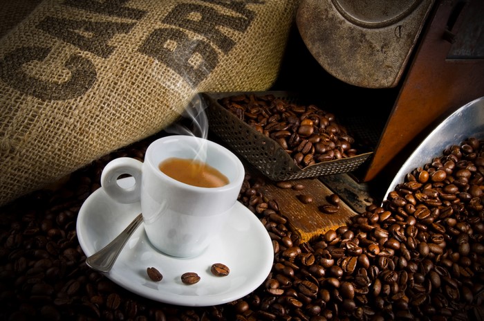 Espresso cup with coffee beans and burlap sack