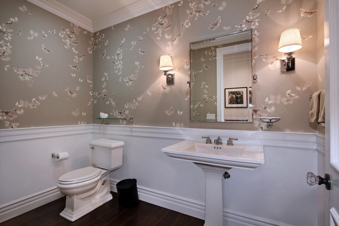 Bathroom with butterfly wallpaper and pedestal sink