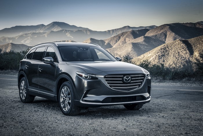 2015 Mazda CX-9 SUV parked on gravel road with mountains