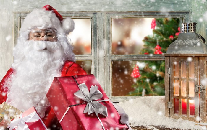 Santa Claus with Gifts by a Snowy Window