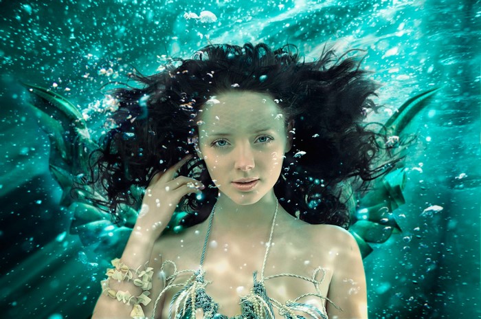 Mermaid underwater with bubbles and light rays
