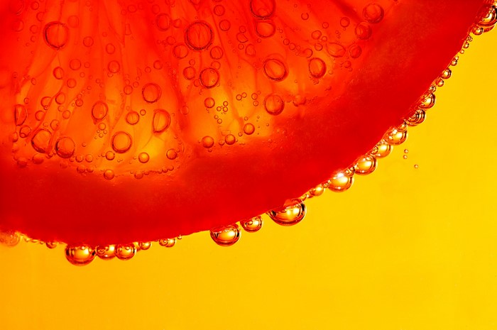 Close-up of a slice of orange with bubbles