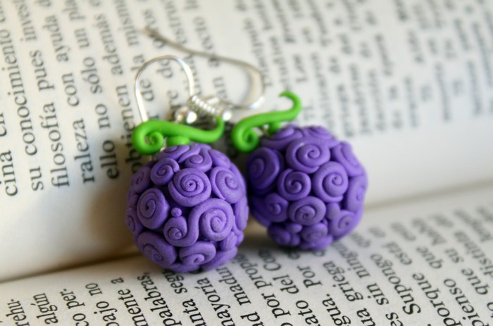Purple Devil Fruit Earrings on Book Pages