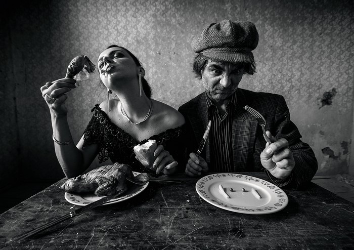 Man and woman eating meat