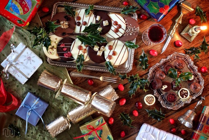 Christmas chocolates and gifts on a wooden table
