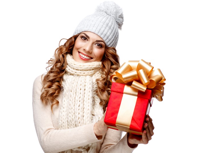 Woman in winter hat holding a gift