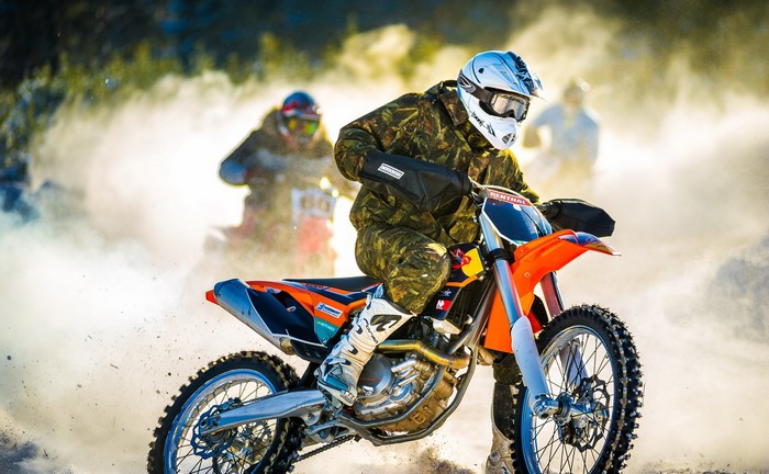 Motorcyclist in camouflage riding a dirt bike