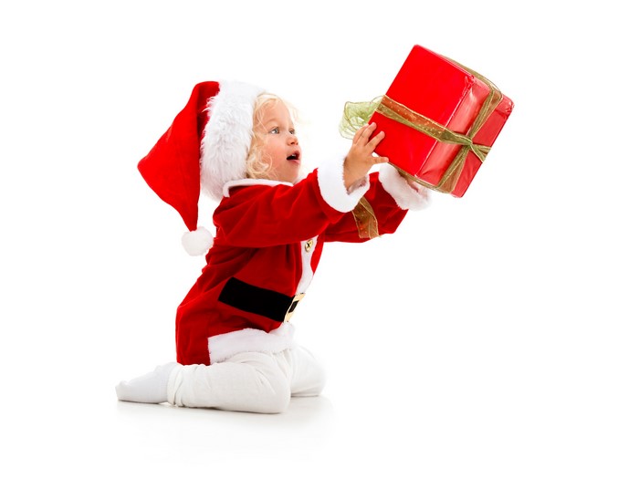 Baby in Santa costume holding a gift