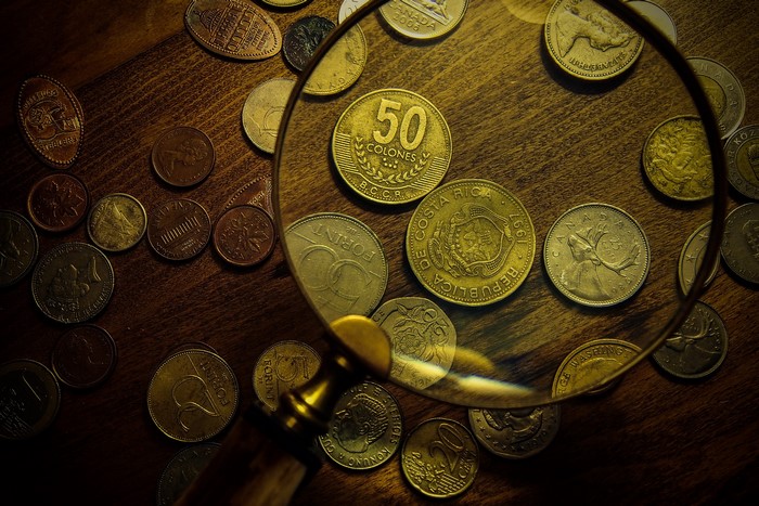 Collection of coins under a magnifying glass